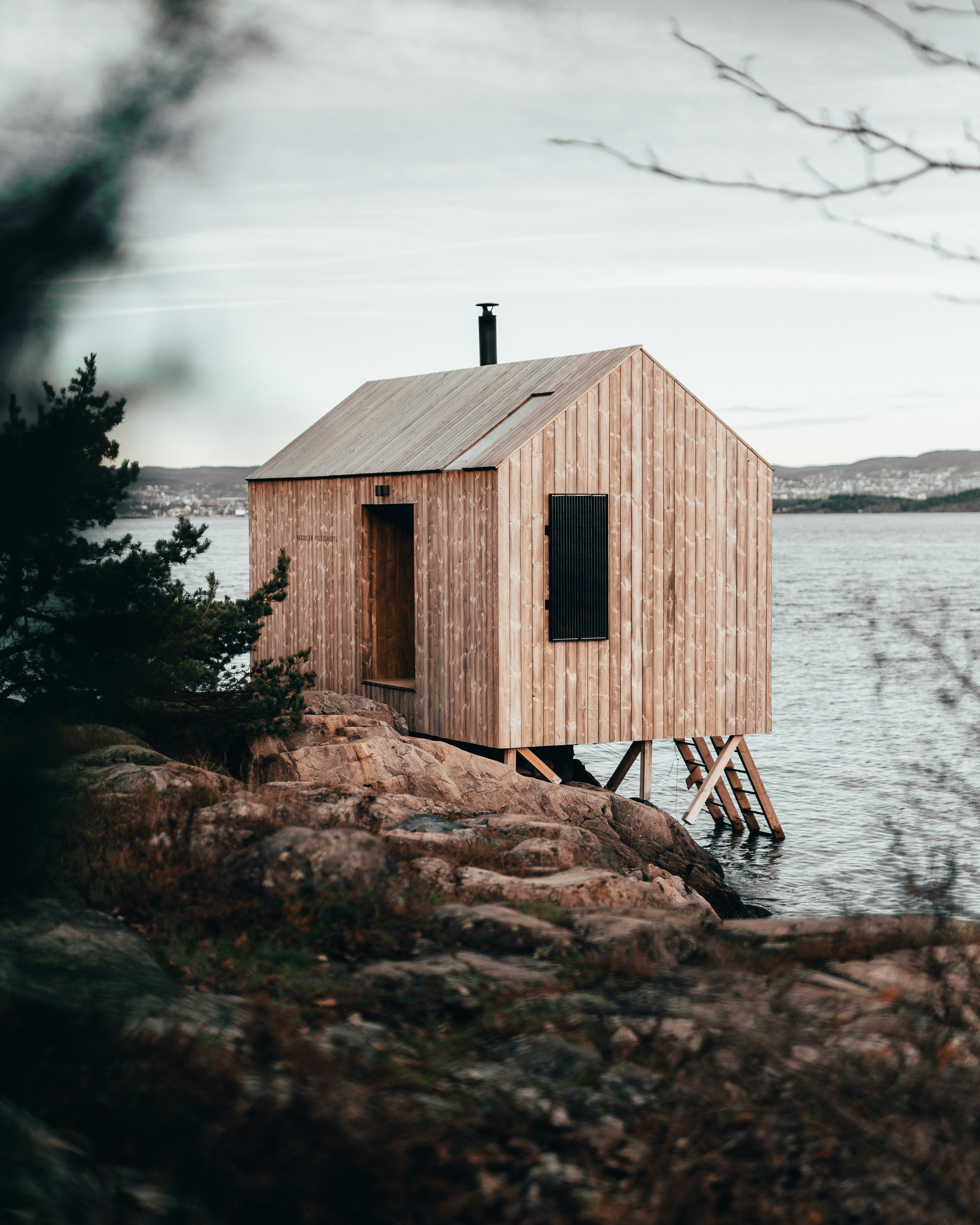 Cabin sauna on stilts by the fjord